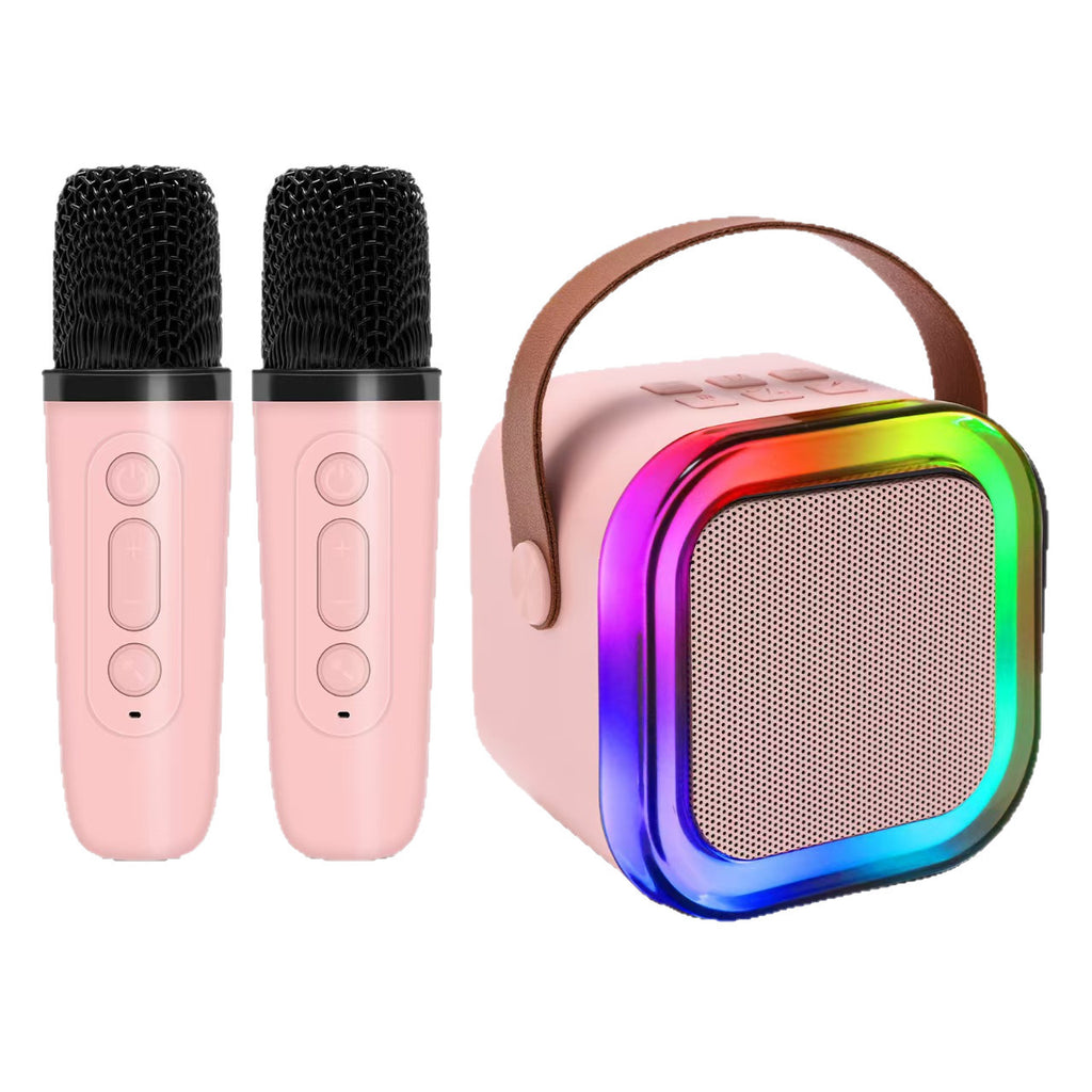 Pink microphone set with a colorful portable Bluetooth speaker on a white background