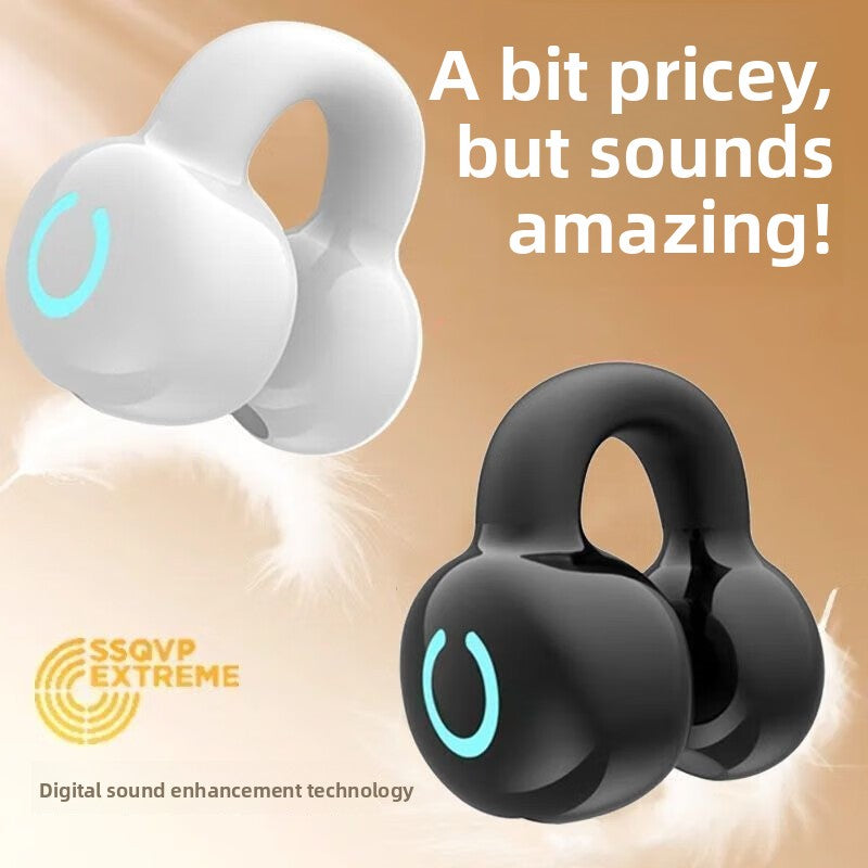 White and black wireless earbuds with digital sound enhancement technology on a beige background.